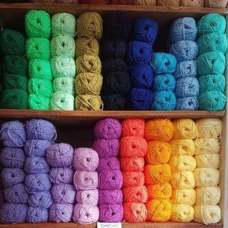 A shelf stocked with yarns